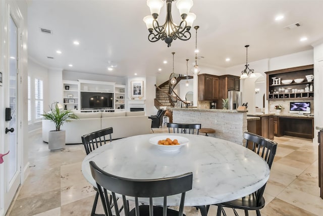 dining space featuring an inviting chandelier and crown molding