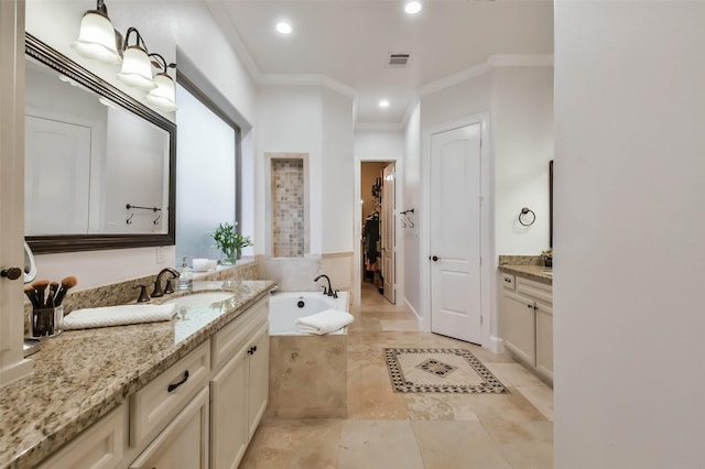 bathroom featuring vanity, crown molding, and tiled bath