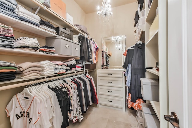 walk in closet featuring a chandelier