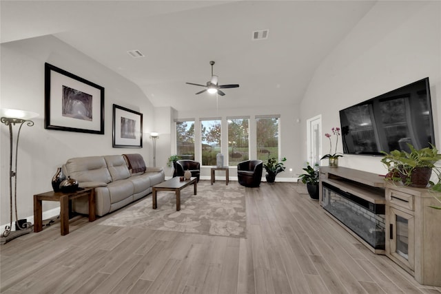 living room with light hardwood / wood-style floors, ceiling fan, and lofted ceiling