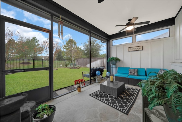 sunroom / solarium featuring ceiling fan