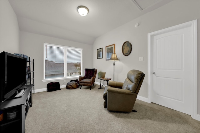 sitting room featuring light colored carpet and lofted ceiling