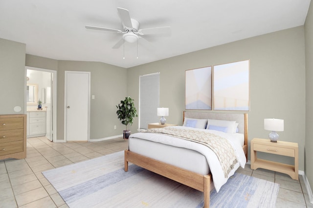 tiled bedroom with ceiling fan and ensuite bath