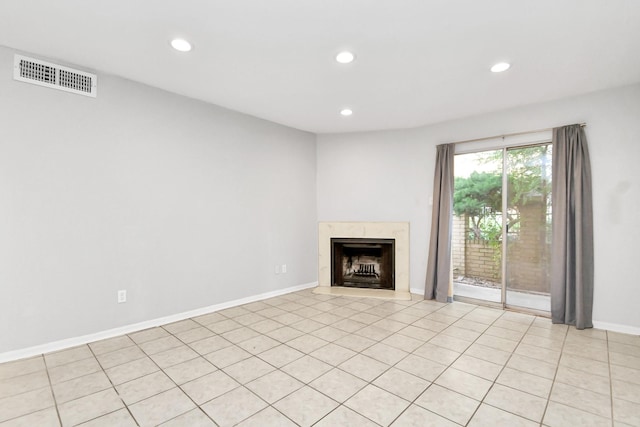 unfurnished living room with light tile patterned flooring and a high end fireplace