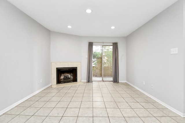 unfurnished living room featuring a fireplace and light tile patterned floors