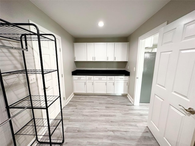 kitchen featuring white cabinets and light hardwood / wood-style floors