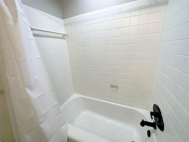 bathroom with shower / tub combo with curtain