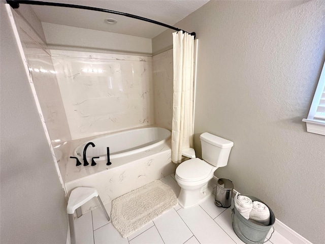 bathroom featuring tile patterned floors, shower / bath combination with curtain, and toilet