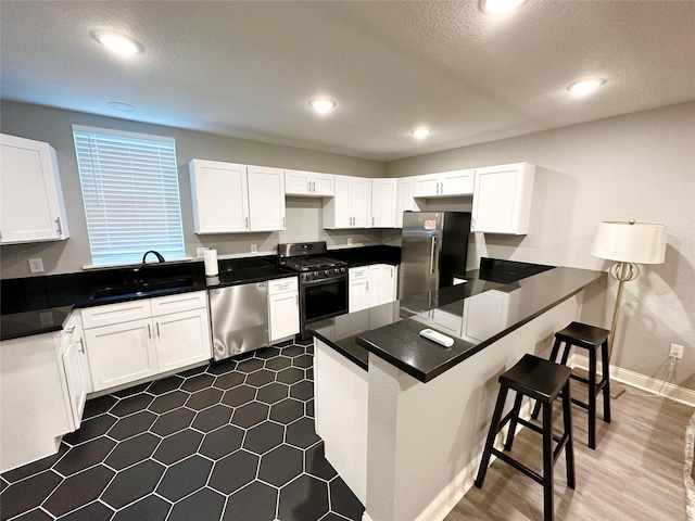 kitchen with white cabinets and appliances with stainless steel finishes