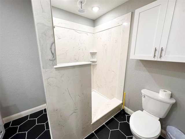 bathroom with tile patterned floors, toilet, and walk in shower