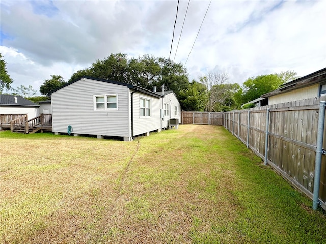 view of yard with central AC unit and a deck