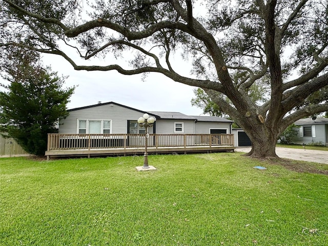 view of front of property with a deck and a front yard