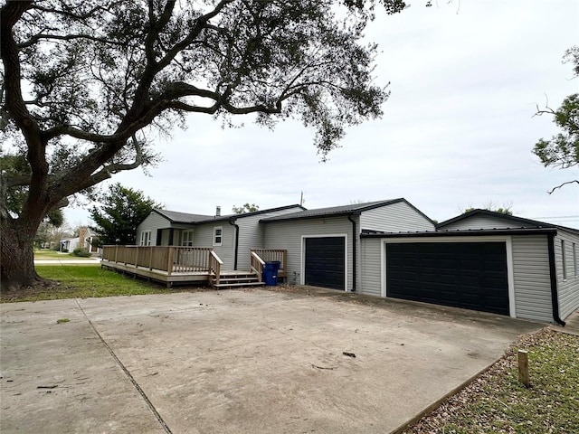 view of side of property with a garage and a wooden deck