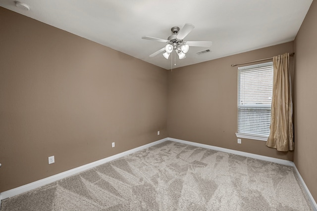 spare room featuring carpet and ceiling fan