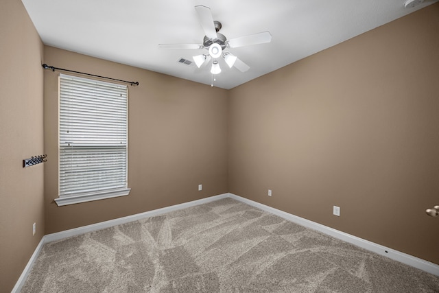 spare room with carpet flooring and ceiling fan