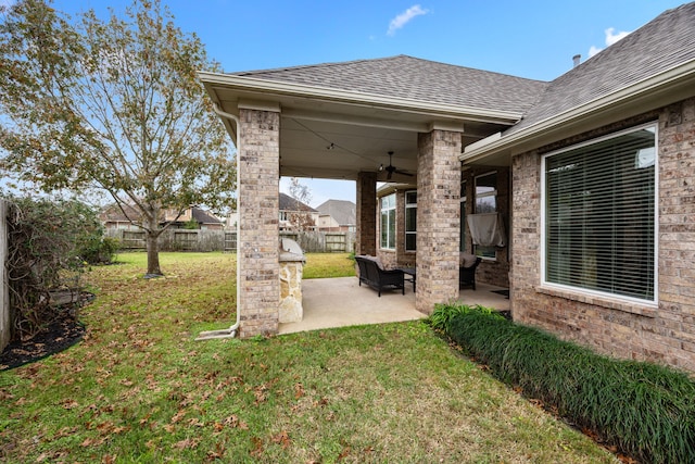 view of yard with area for grilling, ceiling fan, and a patio area