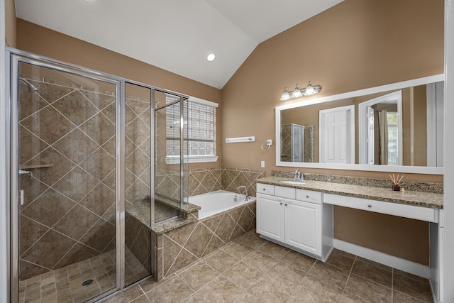 bathroom featuring vanity, independent shower and bath, and vaulted ceiling