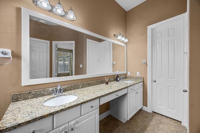 bathroom featuring tile patterned flooring and vanity