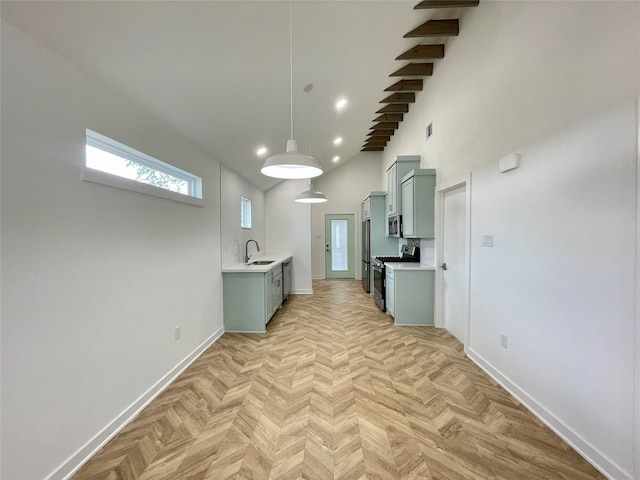 kitchen featuring sink, a towering ceiling, stainless steel appliances, and light parquet floors