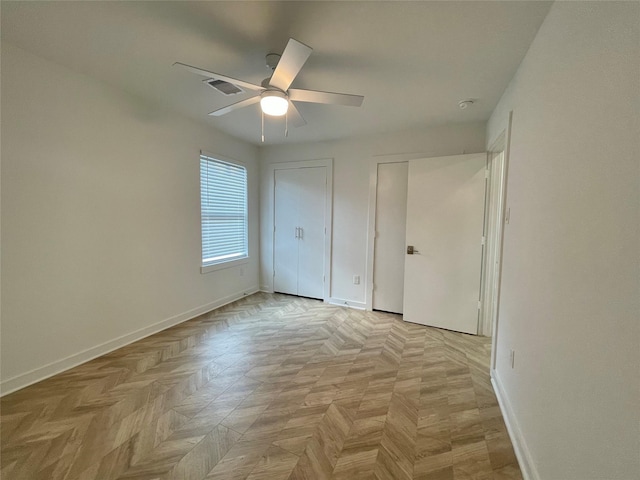 unfurnished bedroom featuring ceiling fan and light parquet floors