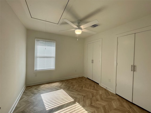 unfurnished bedroom with light parquet floors and ceiling fan