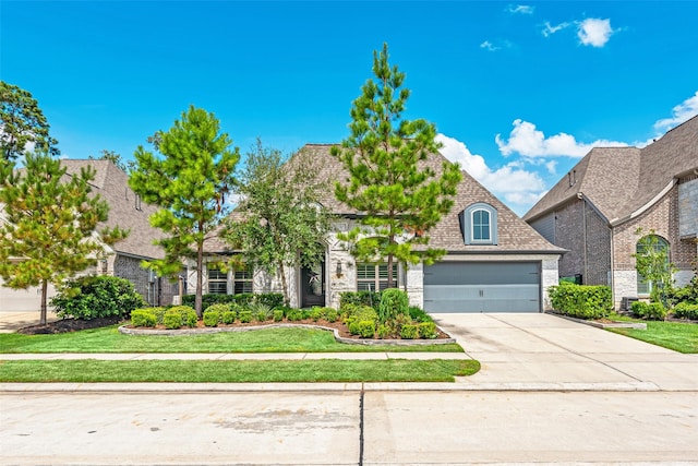 view of front facade with a front lawn and a garage