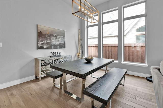 dining room with a chandelier and light hardwood / wood-style floors