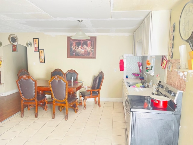 dining area with sink and light tile patterned floors