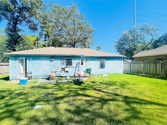 rear view of house with a lawn