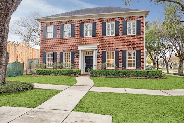 colonial-style house with a front lawn