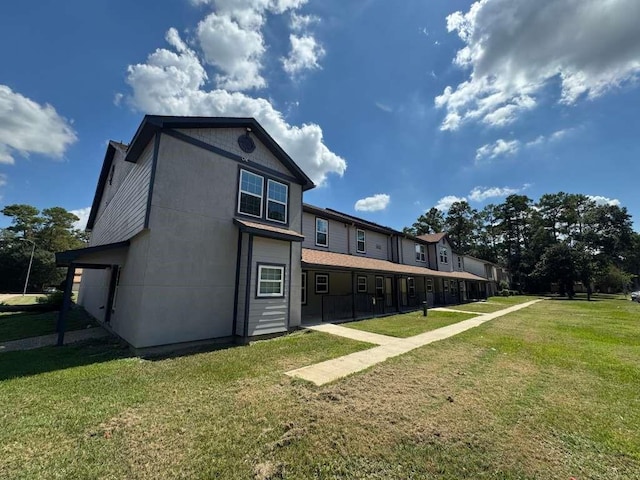 rear view of property featuring a lawn