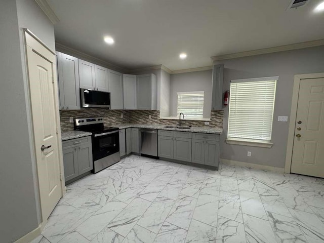 kitchen featuring gray cabinetry, sink, and stainless steel appliances