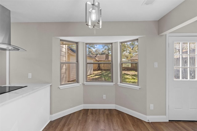 unfurnished dining area featuring hardwood / wood-style floors and a healthy amount of sunlight