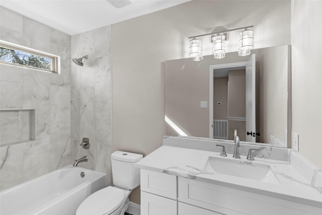 full bathroom featuring toilet, vanity, and tiled shower / bath