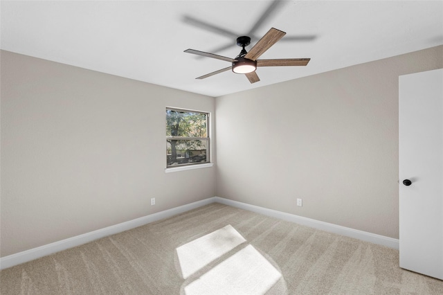 empty room with light colored carpet and ceiling fan