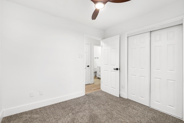 unfurnished bedroom featuring ceiling fan, a closet, and carpet floors