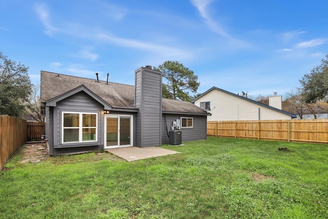 back of house with a patio, a lawn, and central air condition unit