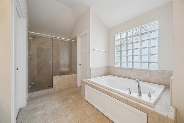 bathroom featuring tile patterned floors, vaulted ceiling, and shower with separate bathtub