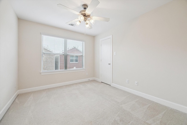 unfurnished room featuring light colored carpet and ceiling fan