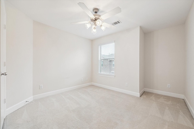 spare room with light carpet and ceiling fan