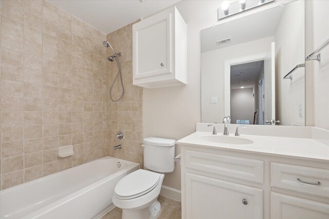 full bathroom with tile patterned flooring, vanity, toilet, and tiled shower / bath