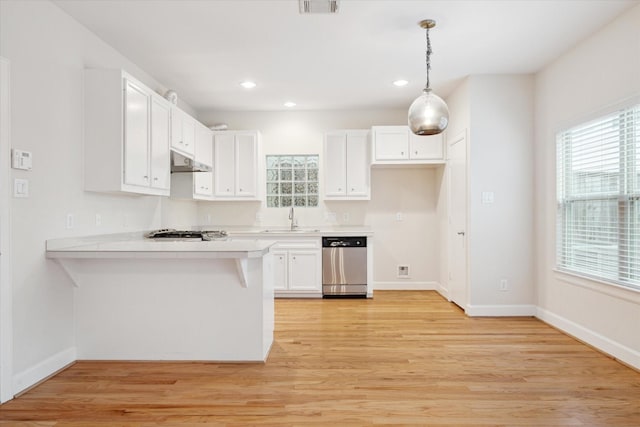 kitchen with dishwasher, sink, kitchen peninsula, decorative light fixtures, and white cabinets