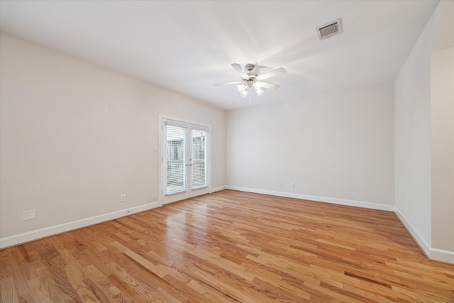 spare room with french doors, light hardwood / wood-style floors, and ceiling fan