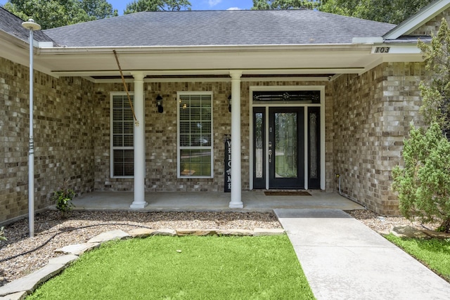 view of exterior entry featuring a porch