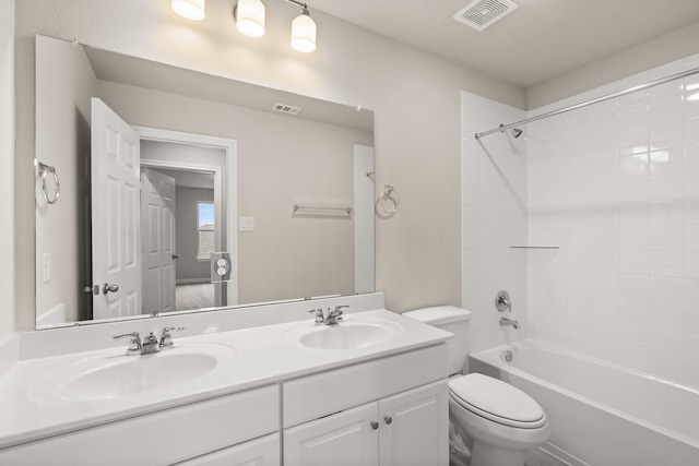 full bathroom featuring bathtub / shower combination, vanity, and toilet