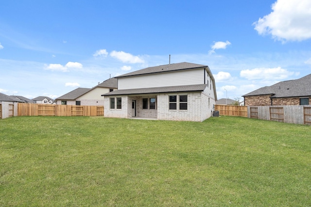 rear view of property with a lawn and central AC