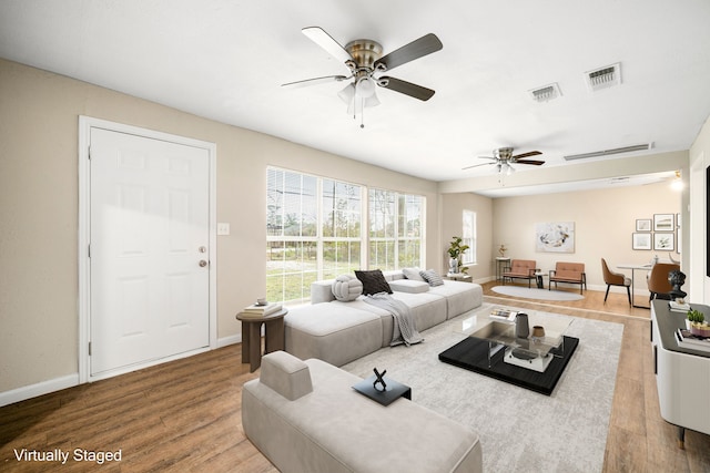 living room with ceiling fan and light wood-type flooring