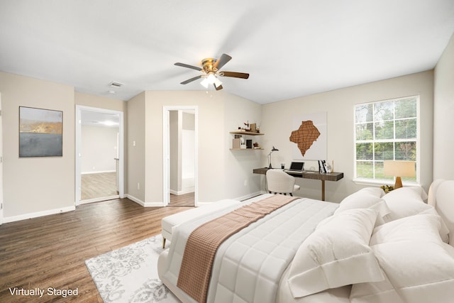 bedroom featuring ceiling fan, dark wood-type flooring, and connected bathroom