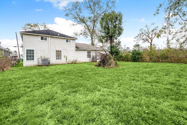 rear view of house featuring a yard