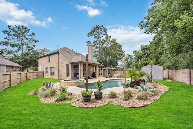 view of pool featuring a lawn, an in ground hot tub, a patio, and a shed